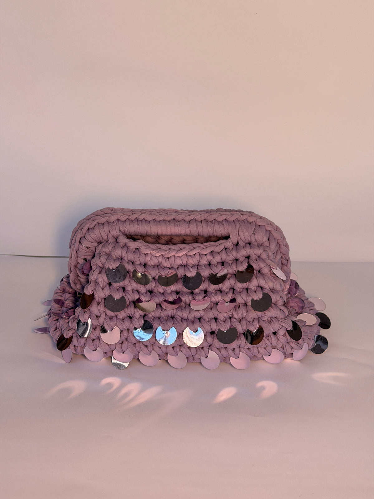 Dusty lilac crochet clutch covered in iridescent paillettes with an integrated top handle