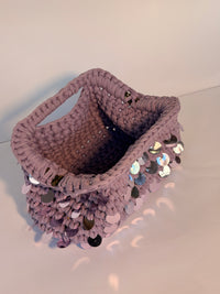Dusty lilac crochet clutch covered in iridescent paillettes with an integrated top handle