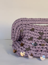 Dusty lilac crochet clutch covered in iridescent paillettes with an integrated top handle