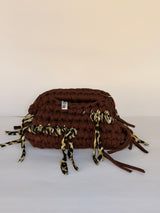 Warm brown crochet clutch with a leopard-print fringe and integrated top handle