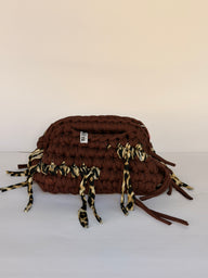 Warm brown crochet clutch with a leopard-print fringe and integrated top handle