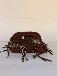 Warm brown crochet clutch with a leopard-print fringe and integrated top handle