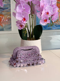 Dusty lilac crochet clutch covered in iridescent paillettes with an integrated top handle
