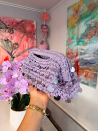 Dusty lilac crochet clutch covered in iridescent paillettes with an integrated top handle