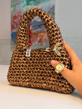 Chunky rounded top handle on the Suki antique gold metallic crochet purse