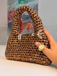 Chunky rounded top handle on the Suki antique gold metallic crochet purse
