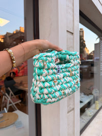 Seaglass green and cream striped crochet bag with a braided top handle and gold shell charms
