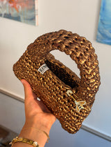 Close-up of the metallic ribbon yarn stitch on the antique gold Suki purse