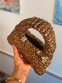 Close-up of the metallic ribbon yarn stitch on the antique gold Suki purse