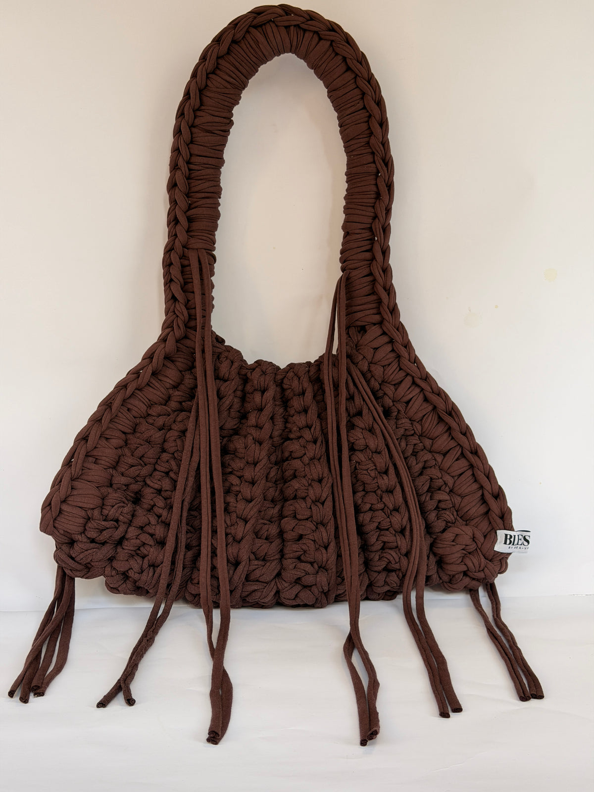 Deep brown crochet Khloe shoulder bag with a long braided handle and loose side ties