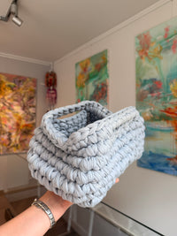 Pale grey crochet clutch worked in a deep bubble stitch