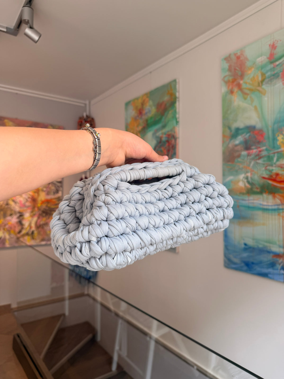 Pale grey crochet clutch worked in a deep bubble stitch