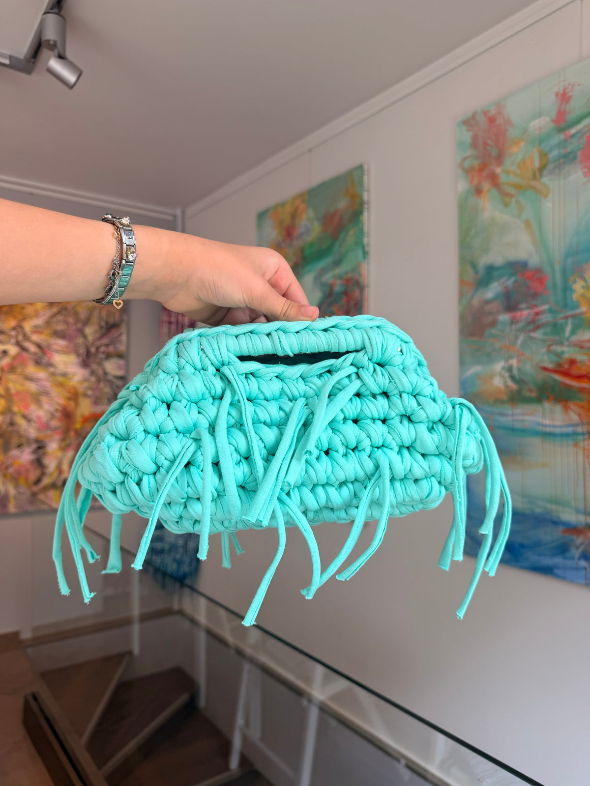 Turquoise crochet clutch with a long fringe