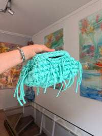 Turquoise crochet clutch with a long fringe