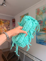 Turquoise crochet clutch with a long fringe
