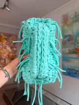 Turquoise crochet clutch with a long fringe