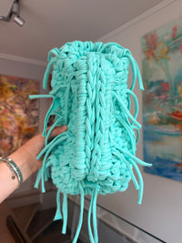 Turquoise crochet clutch with a long fringe