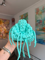 Turquoise crochet clutch with a long fringe