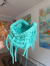 Turquoise crochet clutch with a long fringe