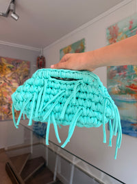 Turquoise crochet clutch with a long fringe
