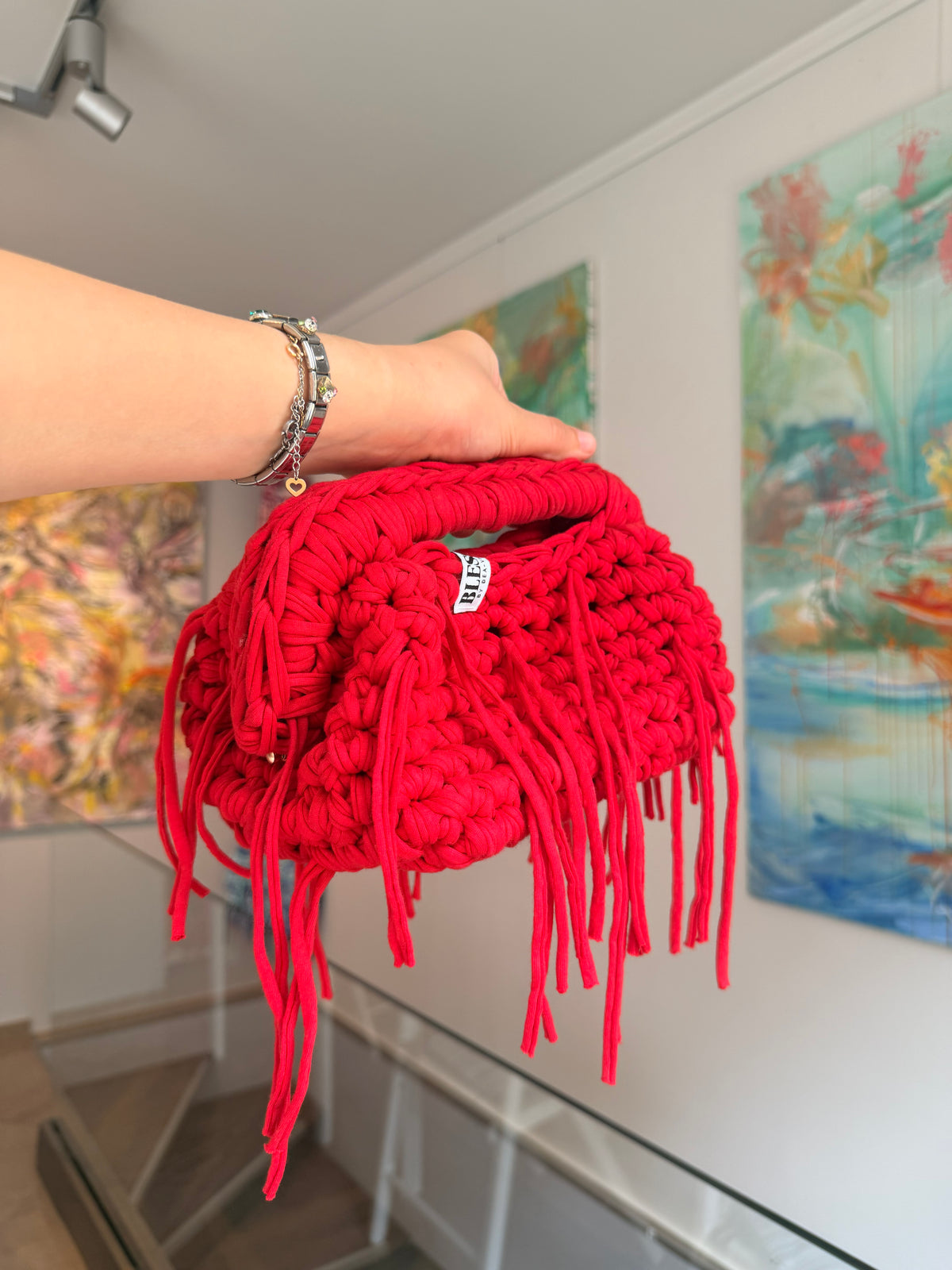 Bright red crochet clutch with a long fringe