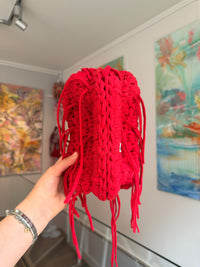 Bright red crochet clutch with a long fringe