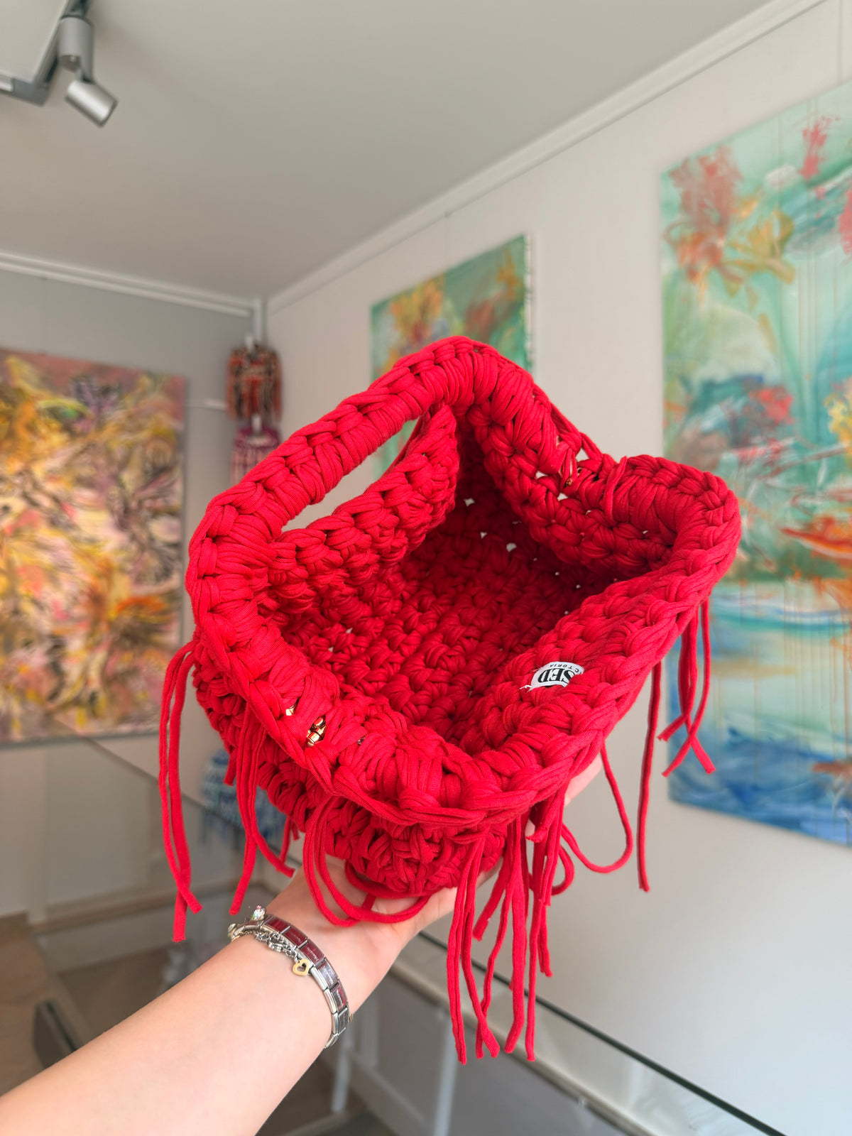 Bright red crochet clutch with a long fringe