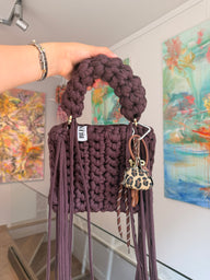 Brown crochet bag showing gold ring handle detail
