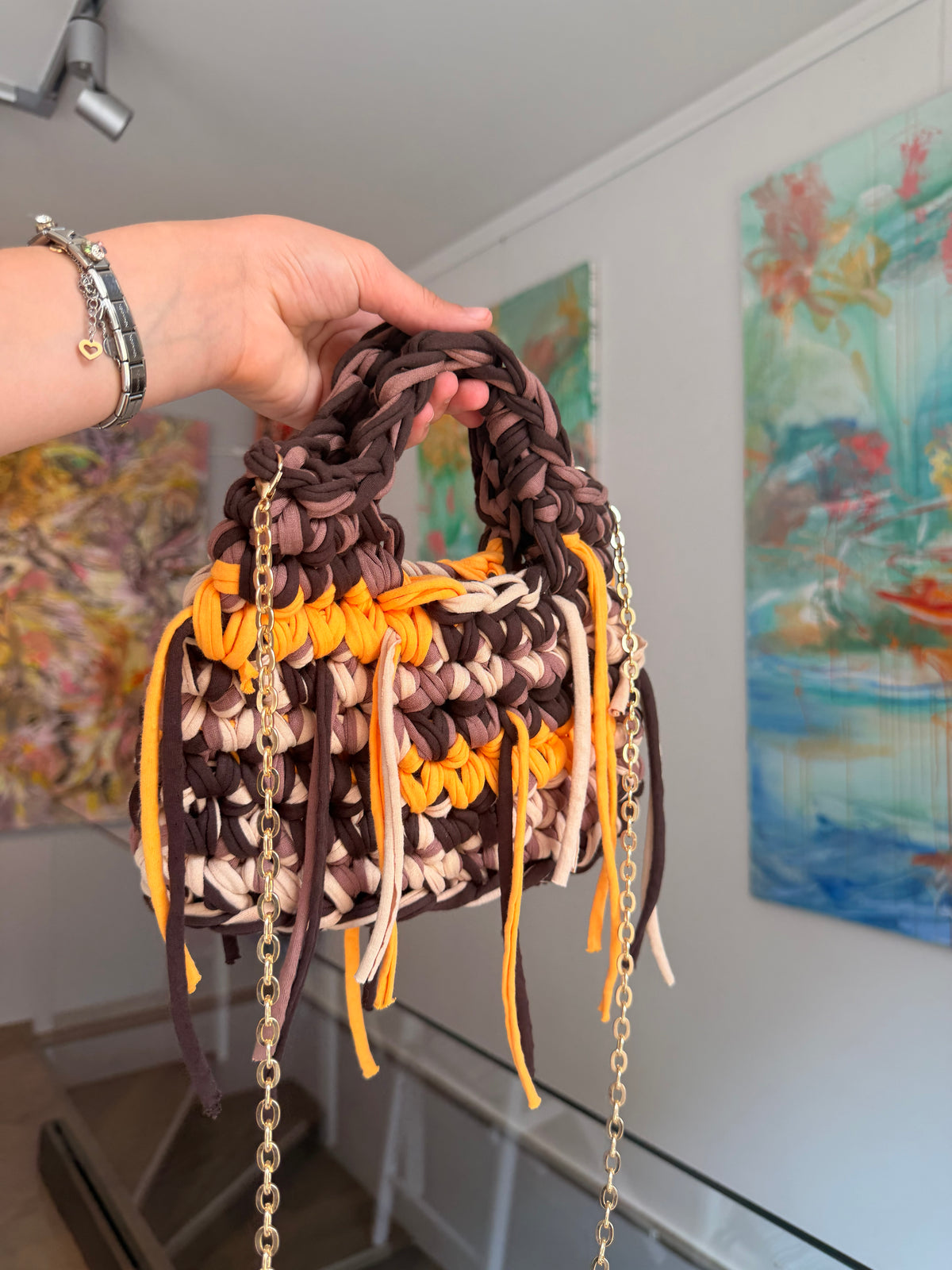 Blessed by DV Sasha crochet bag with long multi-colour fringe and a gold chain shoulder strap
