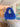 Electric blue crochet shoulder bag with an integrated cut-out handle