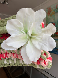 Sage green crochet clutch with a raspberry and cream stripe and a silk flower at the handle