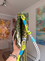 Olive green crochet crossbody bag with a corded strap and long fringe