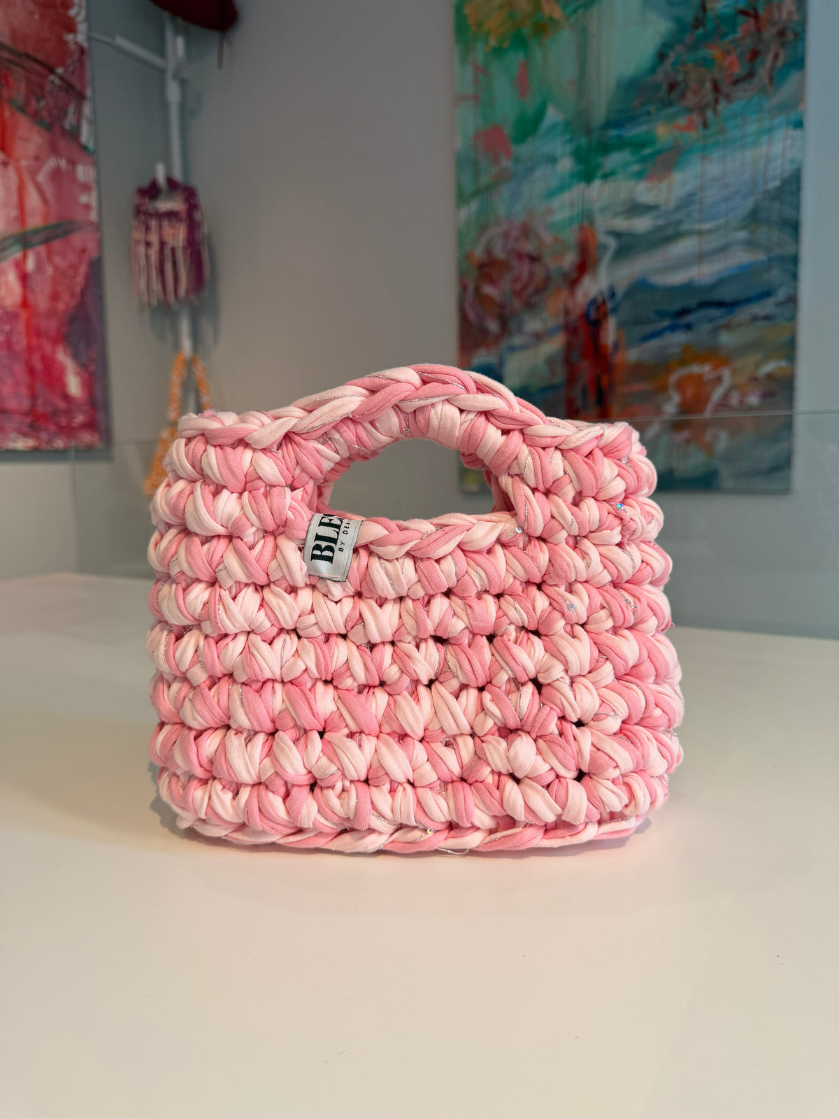 Soft pink crochet bag with a silver thread and a chunky braided top handle