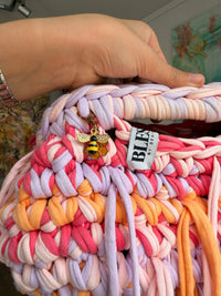 Multicoloured crochet clutch in coral, lilac, peach and apricot with a fringe all round