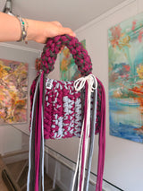 Berry and pale grey crochet bag with a braided top handle, cream bow and long fringe