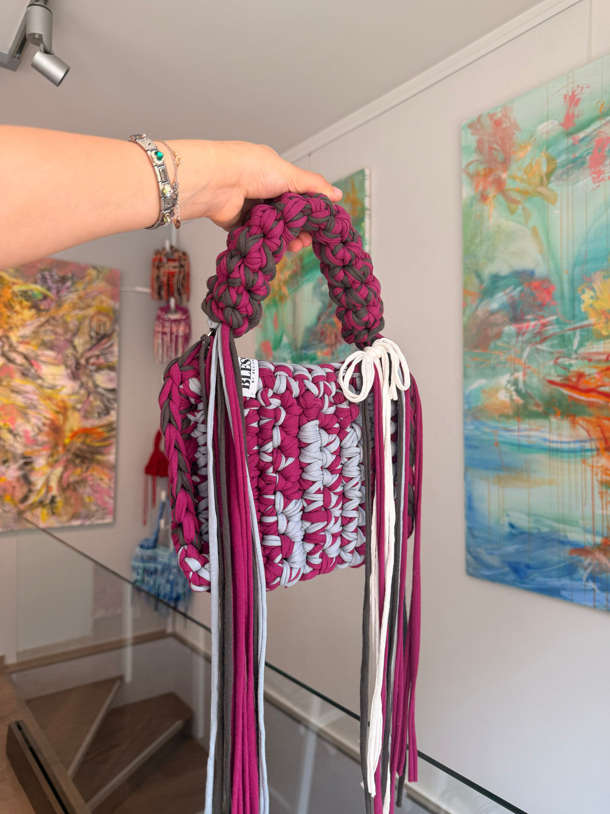 Berry and pale grey crochet bag with a braided top handle, cream bow and long fringe