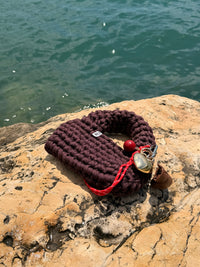 Deep plum-brown crochet bag with a rounded top handle