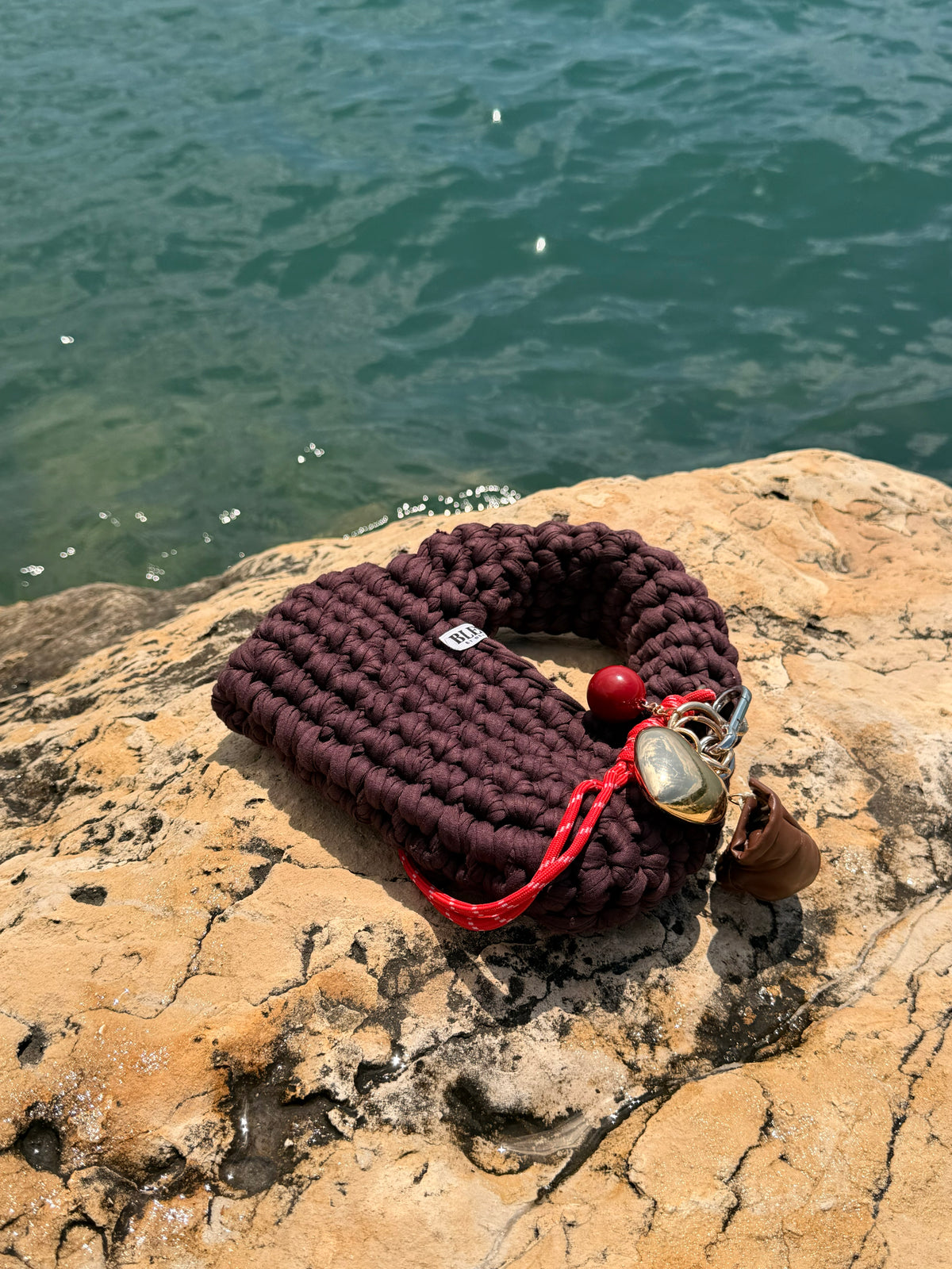 Deep plum-brown crochet bag with a rounded top handle