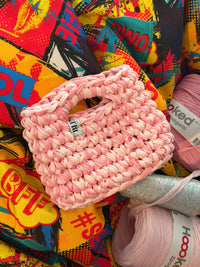 Soft pink crochet bag with a silver thread and a chunky braided top handle