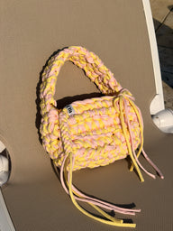 Lemon and pink crochet bag with a big rounded handle, gold heart clasp and long ties