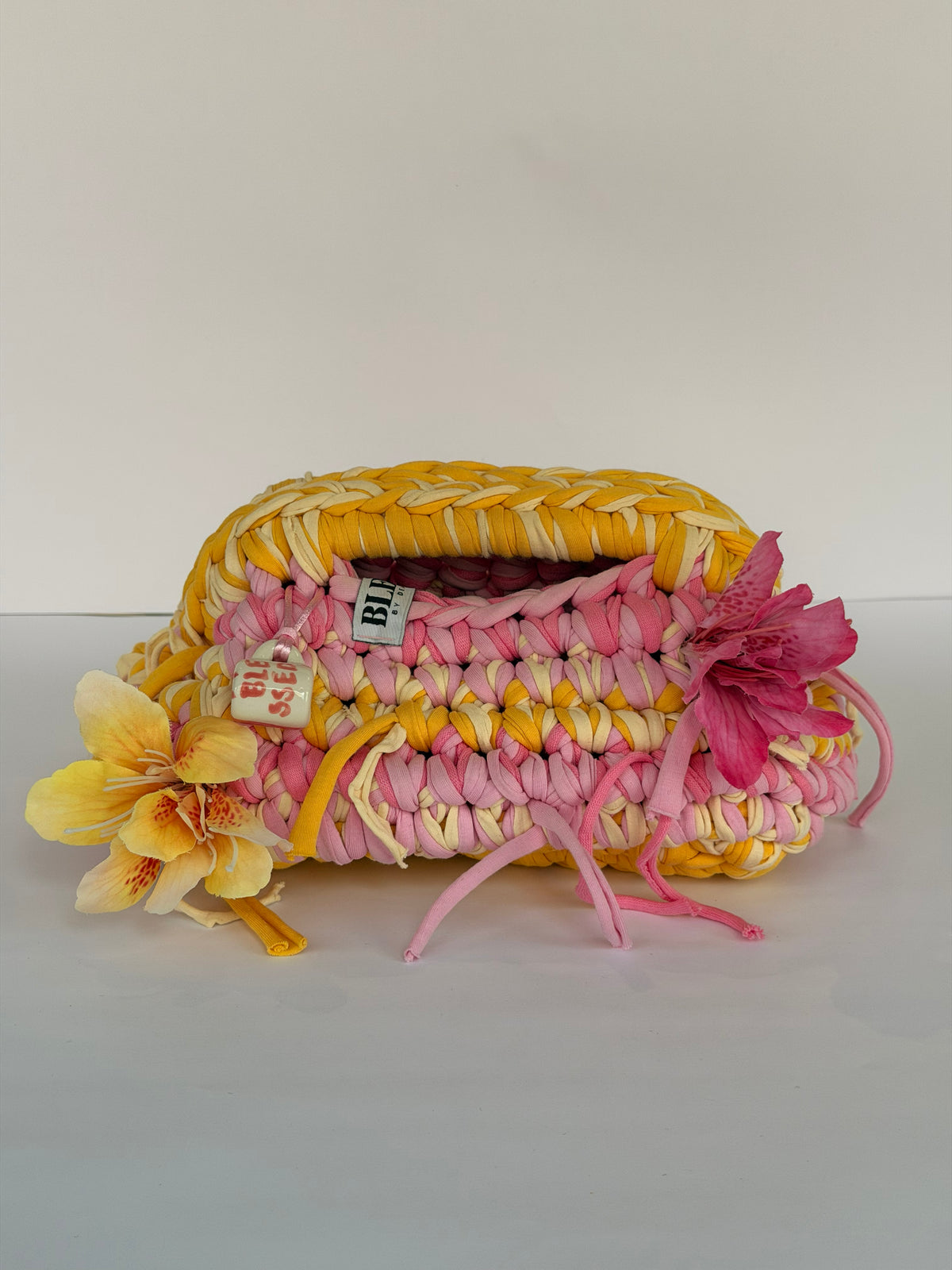 Handmade crochet Marigold and Rose clutch in pink, marigold and cream cotton tube yarn