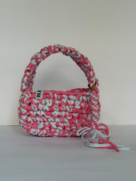 Pink and pale blue crochet shoulder bag with a big rounded handle, gold clasp and long ties