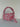 Pink and pale blue crochet shoulder bag with a big rounded handle, gold clasp and long ties