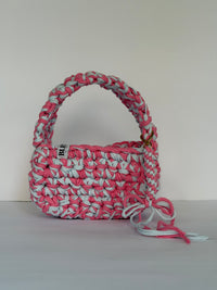 Pink and pale blue crochet shoulder bag with a big rounded handle, gold clasp and long ties