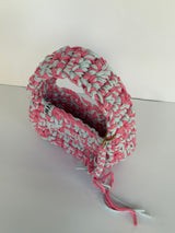 Pink and pale blue crochet shoulder bag with a big rounded handle, gold clasp and long ties