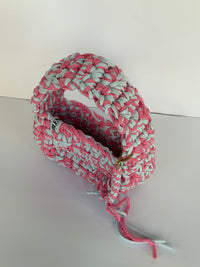 Pink and pale blue crochet shoulder bag with a big rounded handle, gold clasp and long ties