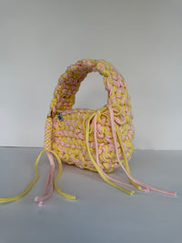 Lemon and pink crochet bag with a big rounded handle, gold heart clasp and long ties