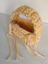 Lemon and pink crochet bag with a big rounded handle, gold heart clasp and long ties
