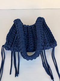 Deep navy crochet shoulder bag with a braided top handle and long side ties