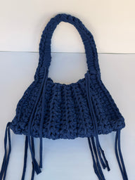 Deep navy crochet shoulder bag with a braided top handle and long side ties